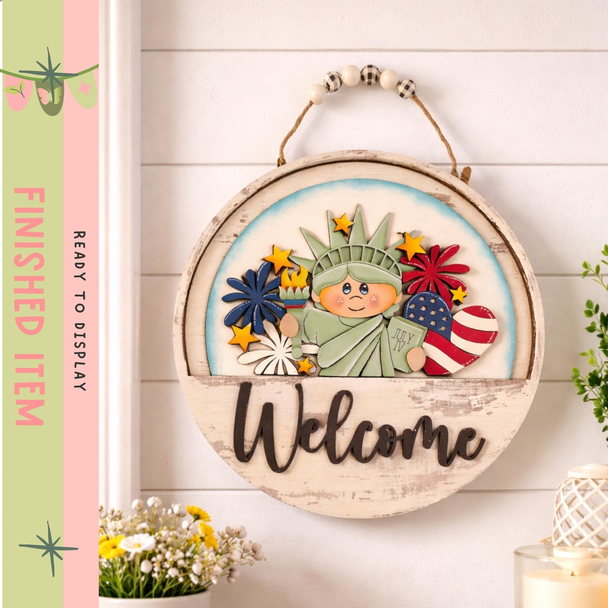 A wooden sign with a cartoon image of the Statue of Liberty and the word "Welcome" is hanging on a wall.