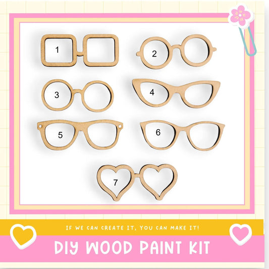 a DIY wood paint kit with various wooden shapes, including glasses, hearts, and other decorative elements, arranged on a white background.