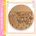 a wooden sign with the text "Sweet Land of Liberty" carved into it, along with a decorative ice cream cone.