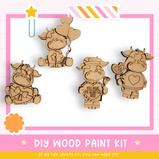 The image is a promotional poster for a DIY wood paint kit, featuring four wooden cow or animal figurines in various poses and holding different objects, such as balloons and flowers.