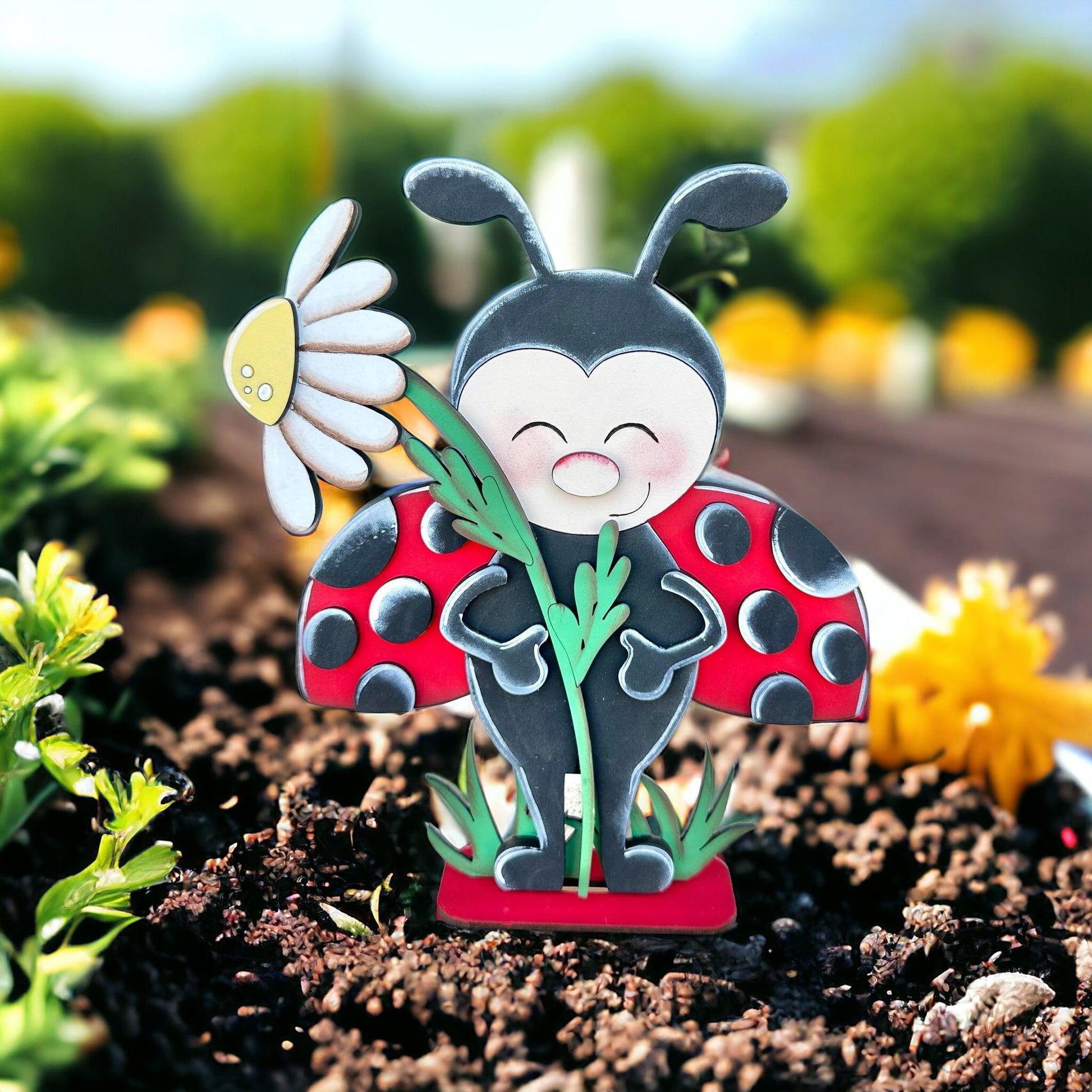 a ladybug figurine sitting on top of a flower pot