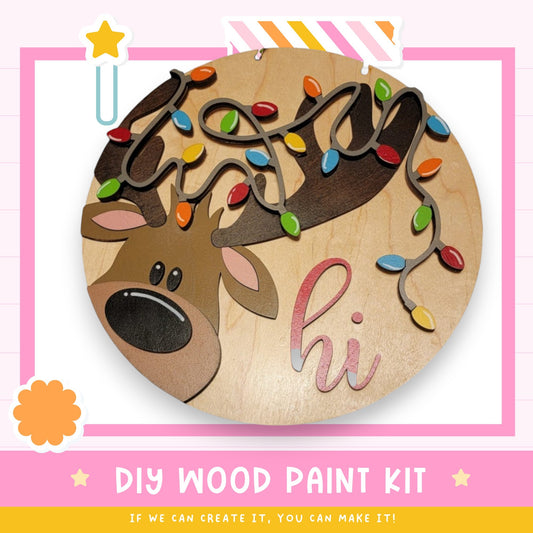 a DIY wood paint kit for creating a wooden decoration with a reindeer and colorful lights.