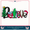 A colorful and whimsical DIY kit for creating a "Believe" sign, featuring various decorative elements such as a Christmas tree, a green Grinch, and a Santa hat.
