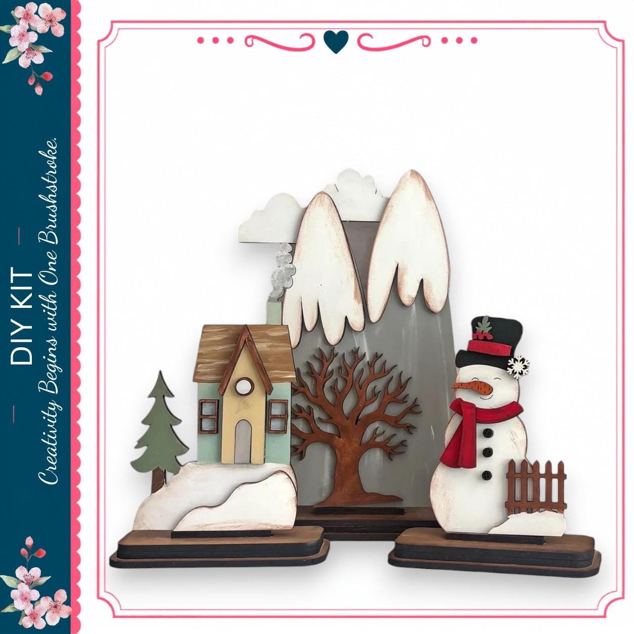 a snowman and a small house, both made of wood and decorated with various winter elements such as a scarf, hat, and carrot nose.
