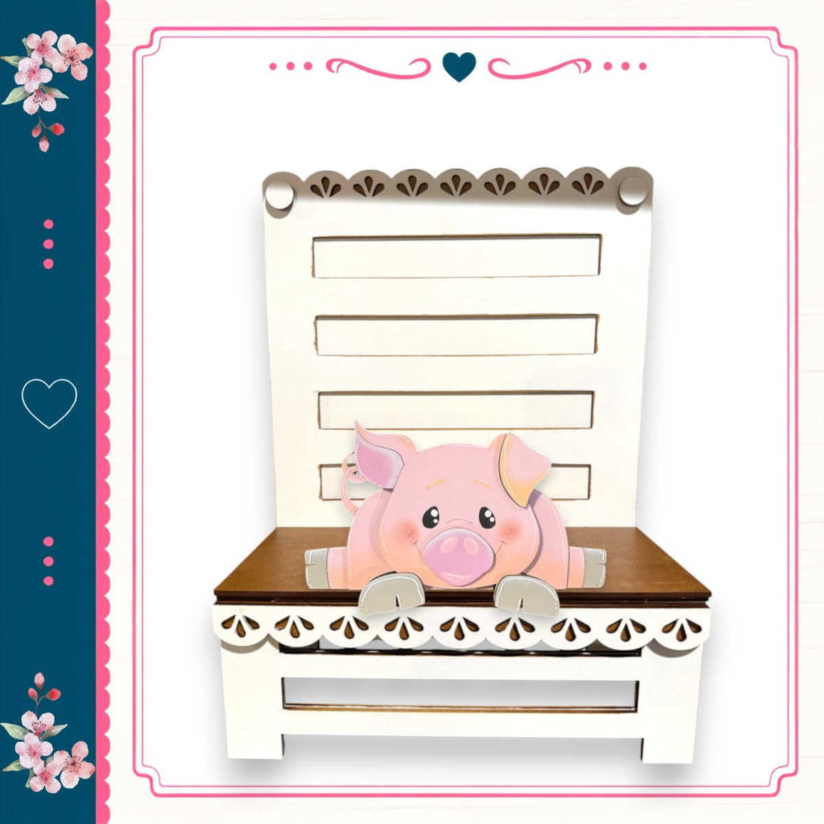 A pink pig sitting on a white wooden bench with decorative trim, surrounded by a floral border.