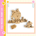 A wooden snowman kit with a snowman, reindeer, and other winter-themed decorations.
