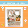 a card with a picture of a bunny in a window