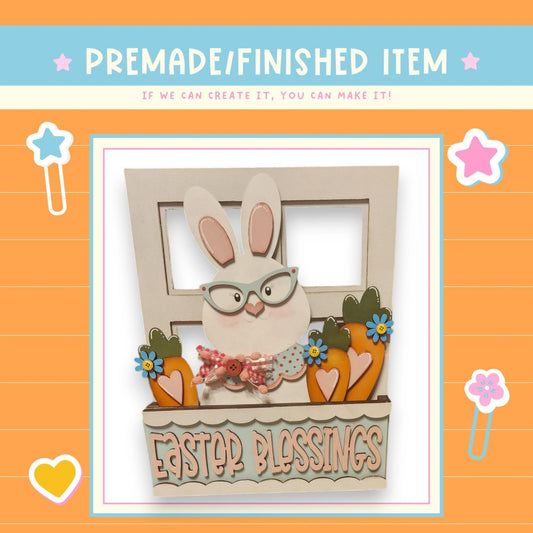 a card with a picture of a bunny in a window