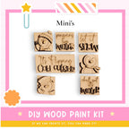 The image is a promotional poster for a DIY wood paint kit, featuring six wooden snowman stickers with winter-themed phrases.