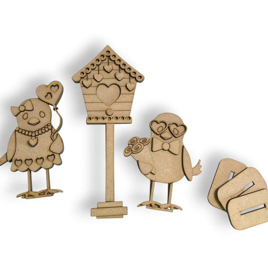 a wooden cutout of a bird and a birdhouse