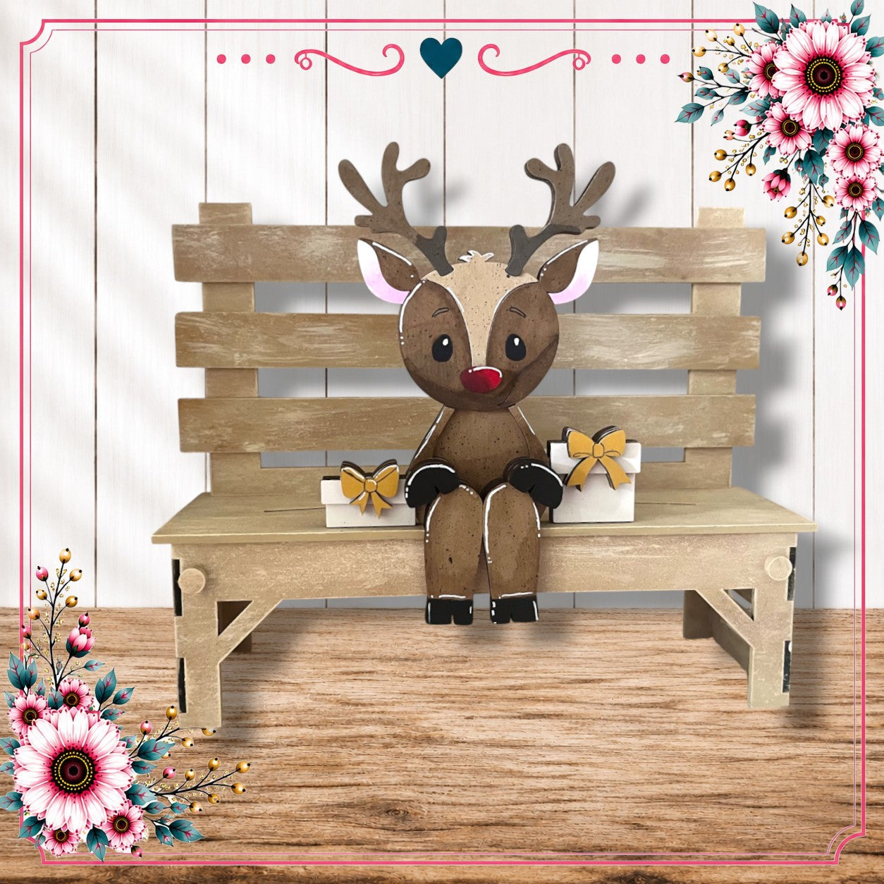 A wooden bench with a reindeer figure sitting on it, surrounded by floral decorations.