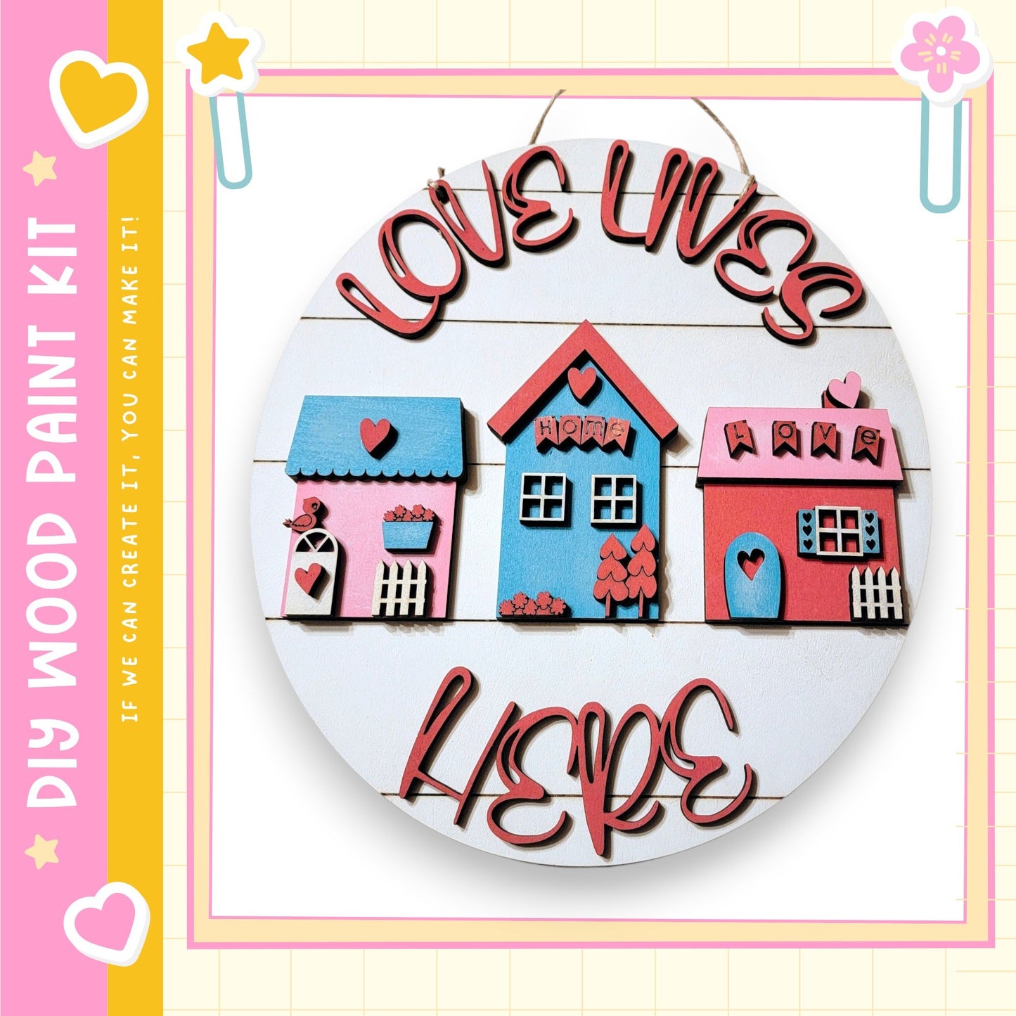 A round wooden sign with three colorful houses and the text "Love Lives Here" written on it.