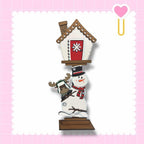 a snowman with a house on top of it