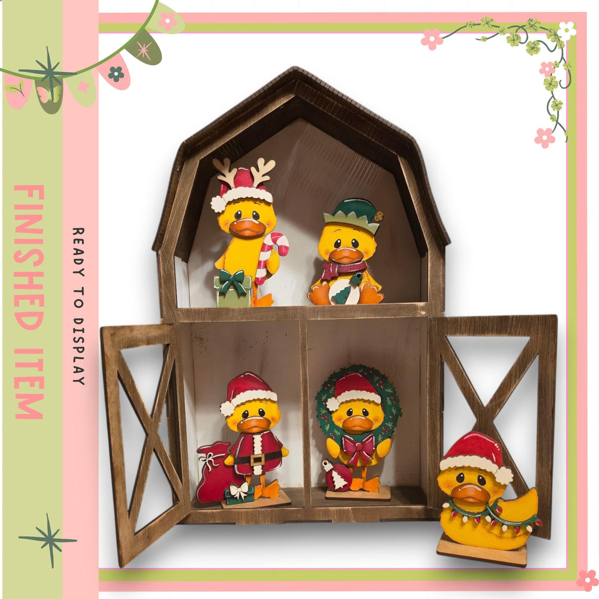 A wooden barn-shaped display case containing four small duck figurines wearing festive hats and costumes, including Santa hats and wreaths.