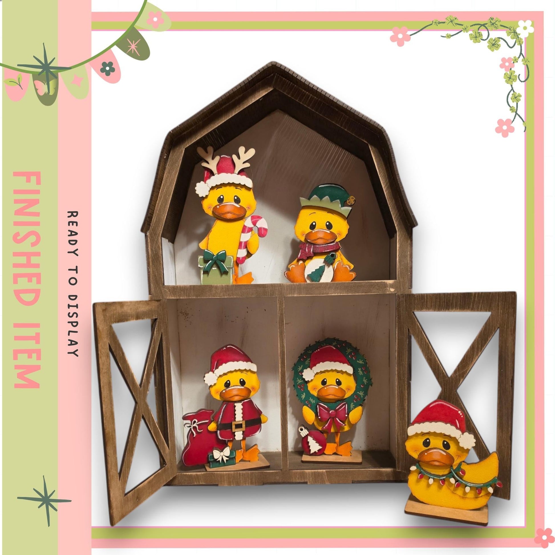 A wooden barn-shaped display case containing four small duck figurines wearing festive hats and costumes, including Santa hats and wreaths.