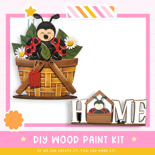 a DIY wood paint kit for creating a wooden basket with a ladybug design. The kit includes a wooden basket with a ladybug sitting inside, and a wooden sign that says "HOME". The kit is presented in a pink and white frame, and the text "DIY WOOD PAINT KIT" is displayed at the bottom.