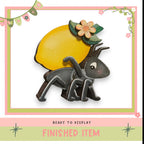 a wooden ant carrying a yellow lemon with a flower on top, and there is a text overlay that says "READY TO DISPLAY FINISHED ITEM".
