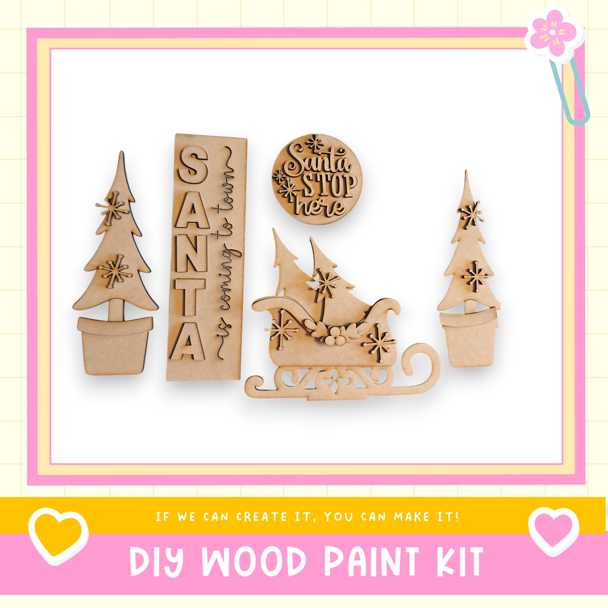 a DIY wood paint kit with various wooden shapes and decorations, including a Santa Claus sign, a snowman, and a Christmas tree.