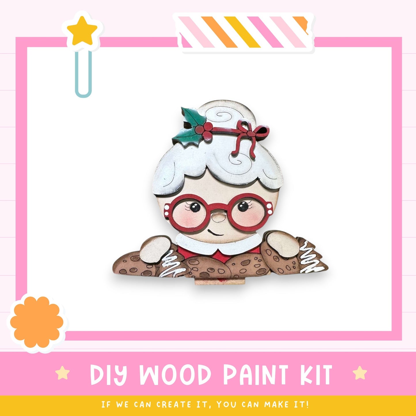 a DIY wood paint kit for creating a wooden character, such as a doll or a toy. The kit includes a wooden doll with red glasses and a bow on its head, along with a star decoration. The kit is presented in a pink and white color scheme, and the text encourages viewers to "If we can create it, you can make it!"
