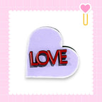 a heart-shaped sign with the word "LOVE" written on it.