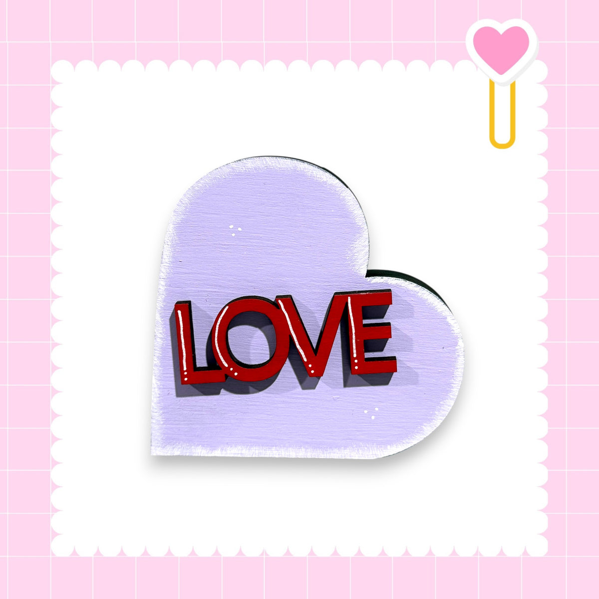 a heart-shaped sign with the word "LOVE" written on it.