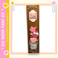 a wooden sign with a decorative design, including heart shapes and cupcake-like elements, and the text "Hello Sweets" written on it.