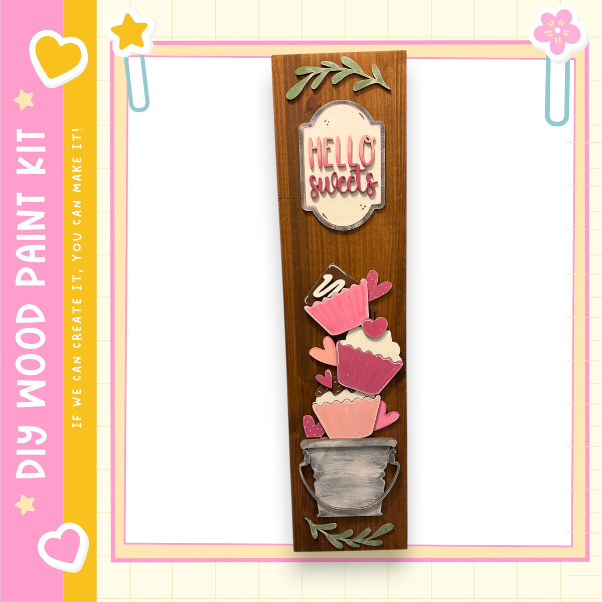 a wooden sign with a decorative design, including heart shapes and cupcake-like elements, and the text "Hello Sweets" written on it.