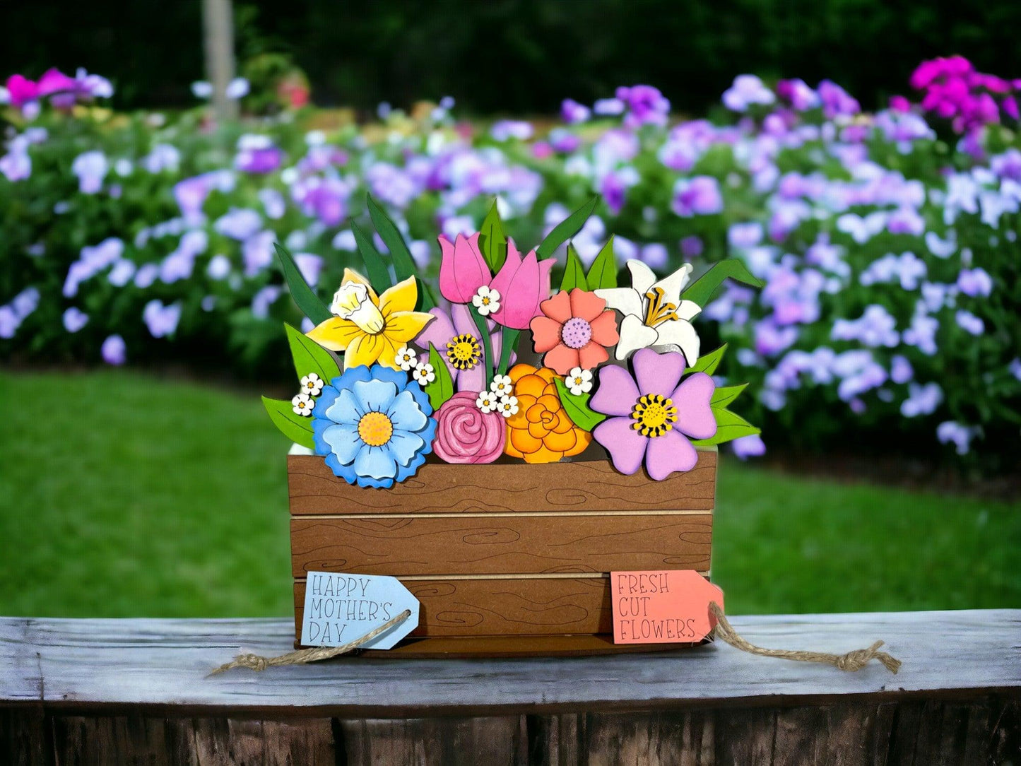 a wooden box filled with flowers on top of a wooden table