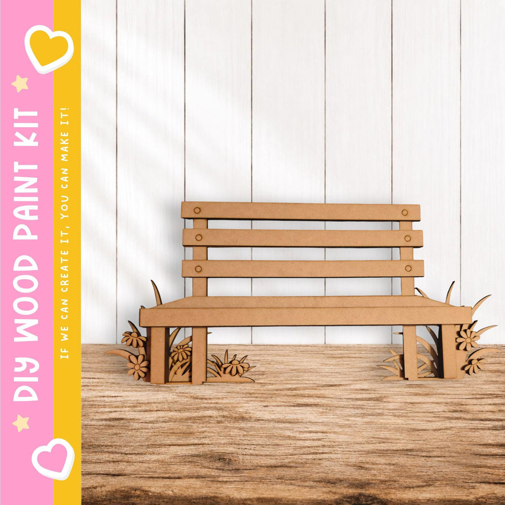 A wooden bench made of cardboard is placed on a wooden floor against a white wall.