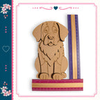 A wooden cutout of a dog is placed next to a ruler, with a heart-shaped design on the left side of the image.