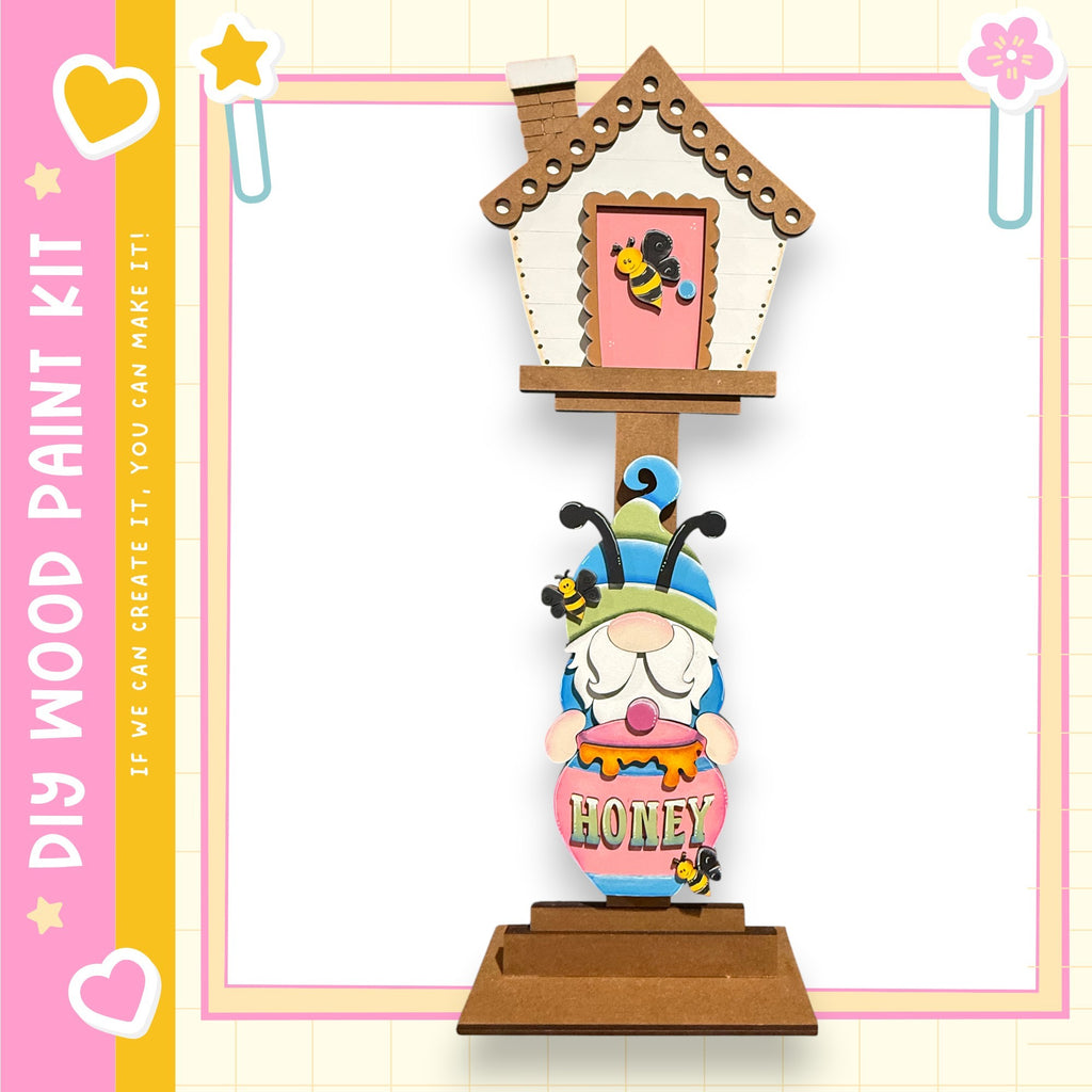 A wooden gnome figurine holding a honey pot, with a small house-like structure above it.