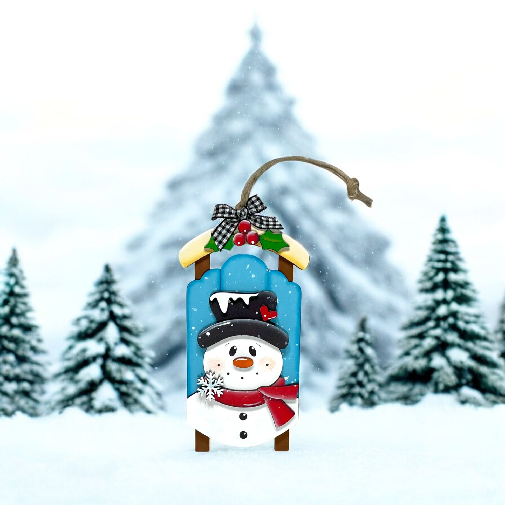 a snowman with a hat and scarf on standing in the snow