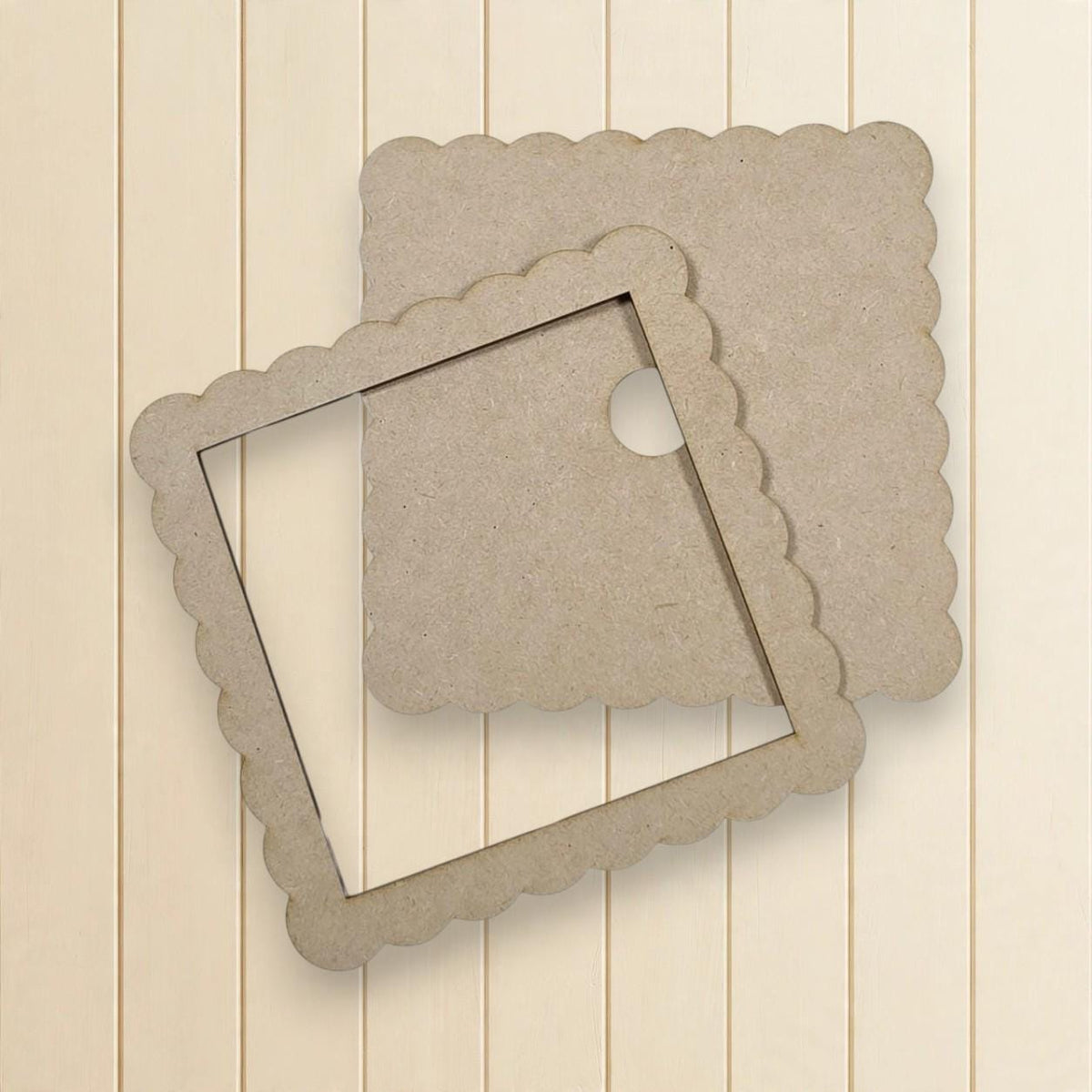 two square cardboard frames with scalloped edges, placed on a wooden background.