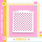 a white stencil with a checkered pattern on a pink background.