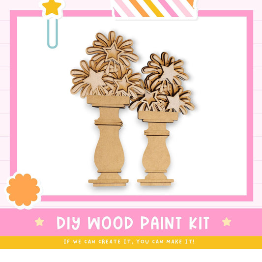 a DIY wood paint kit, with two wooden vases and star-shaped cutouts, set against a pink and white background.