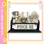 a wooden shelf with various decorative items, including a sign that says "Pinch Me" and a pot of gold coins.