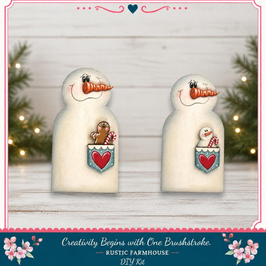 two snowman figurines with hearts in their pouches, set against a white wooden background with Christmas lights and pine trees in the background.