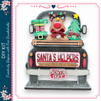 A festive Christmas-themed truck with a Santa Claus reindeer, a Christmas tree, and various holiday decorations.