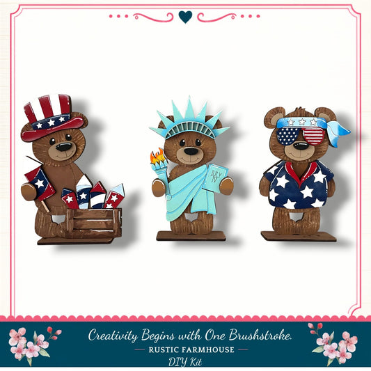 three teddy bears dressed in patriotic outfits, representing the American flag, with one wearing a hat and two wearing shirts with stars and stripes.