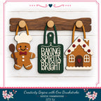 a rustic farmhouse-style kitchen scene with a wooden spoon, a green cutting board with the phrase "Baking Spices Bright", and a gingerbread house.