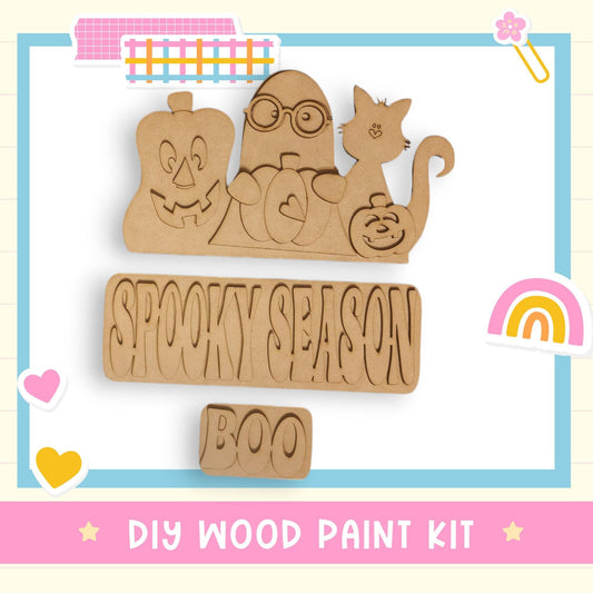 a wooden cutout of a halloween scene with a rainbow in the background