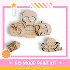 The image is a DIY wood paint kit featuring a skeleton and a pumpkin, with a tag that reads "SHEKIN IN YU BONES".