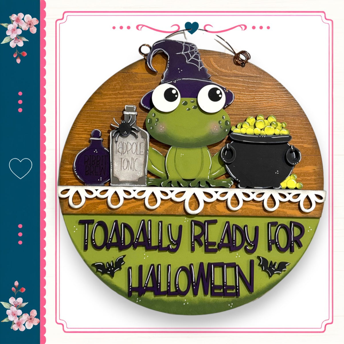 A green frog wearing a witch's hat and holding a cauldron of yellow candies, with the text "TOADALLY READY FOR HALLOWEEN" displayed below.