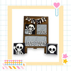 a Halloween-themed display with a skeleton decoration and a sign that reads "These bones love candy".
