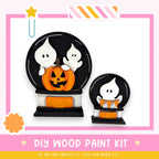 a DIY wood paint kit for creating Halloween decorations, including a carved pumpkin and ghost-shaped objects.