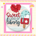 a wooden sign that says sweet land of liberty