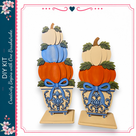 two decorative pumpkin planters, each containing a stack of pumpkins in various colors, including white, orange, and blue. The planters are adorned with blue ribbons and have a decorative design on their sides.