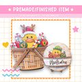 a basket with a duck wearing a Santa hat, and a wooden sign with the word "Welcome" on it.