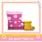 a DIY wood paint kit, with two colorful wooden boot-shaped figures in the foreground. The text below the image encourages creativity and says, "If we can create it, you can make it!"