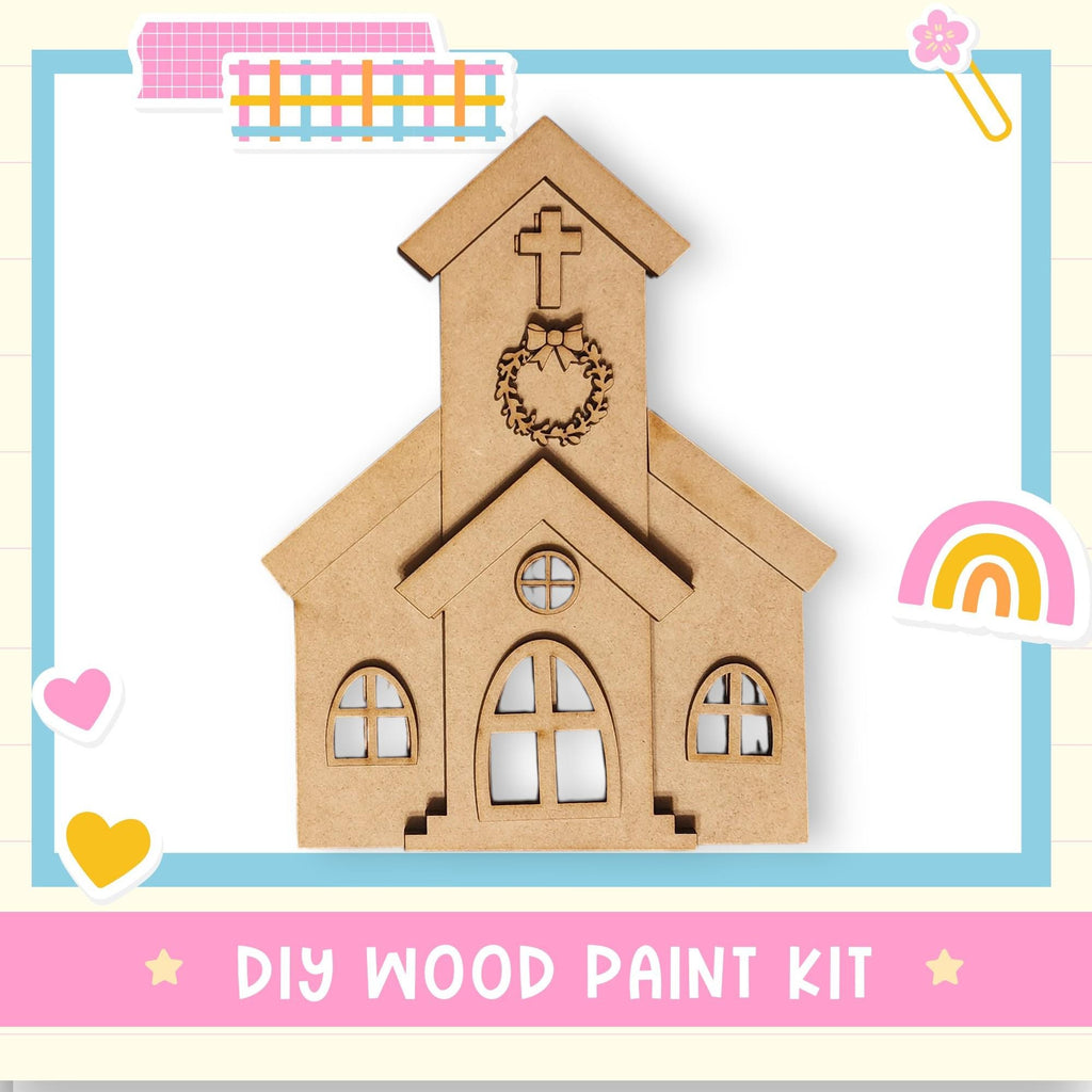 a DIY wood paint kit for creating a wooden church-like structure, with a heart and a rainbow-colored sticker on the right side.
